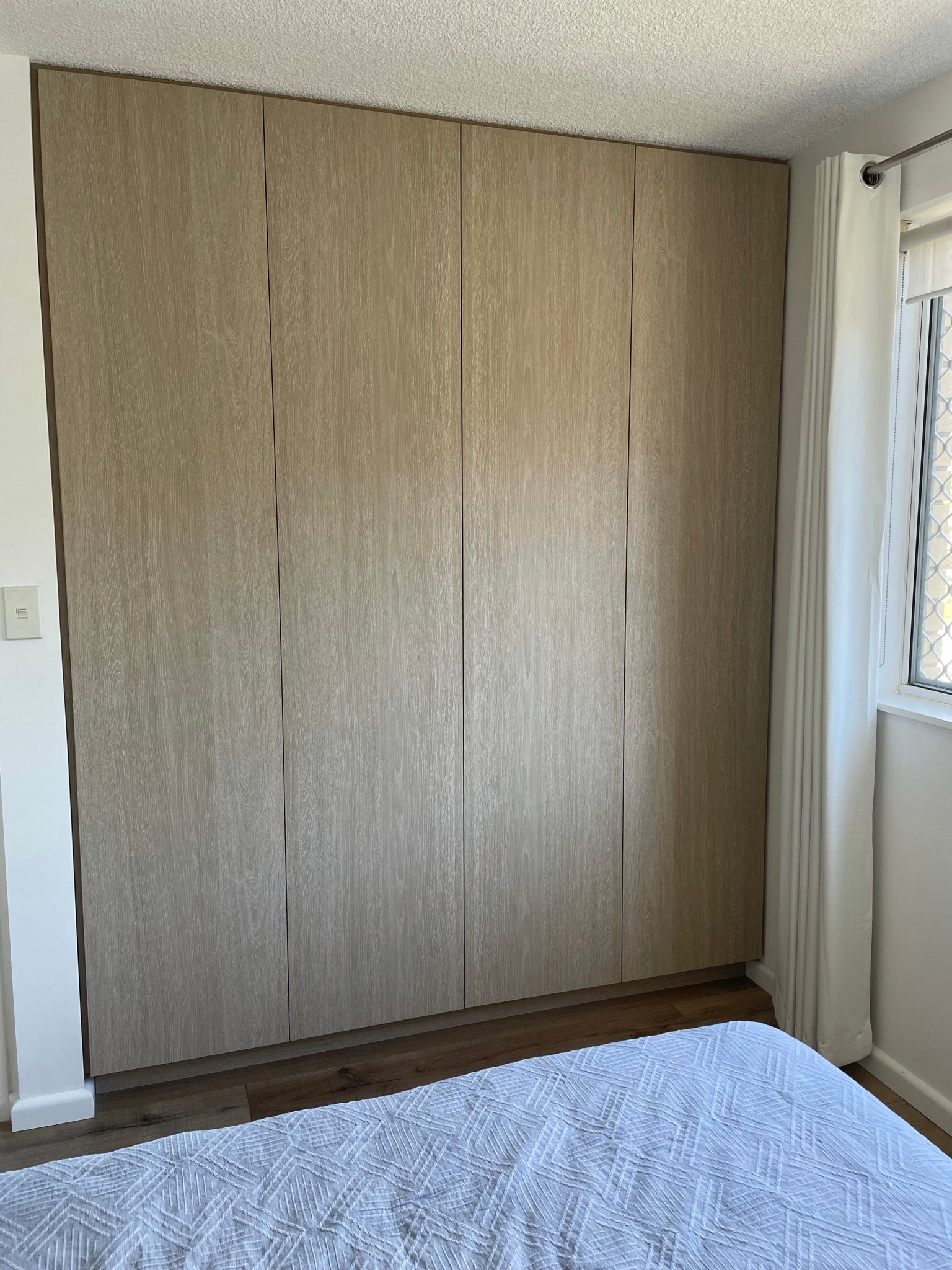 Custom built-in wardrobe with full-height cabinetry and hanging space
